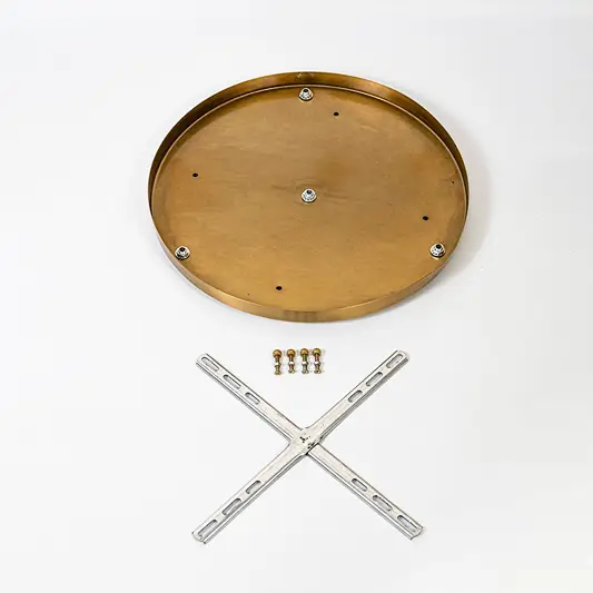 Round metal ceiling plate in warm gold finish shown with cross mounting bracket screws and hardware laid out on white background.