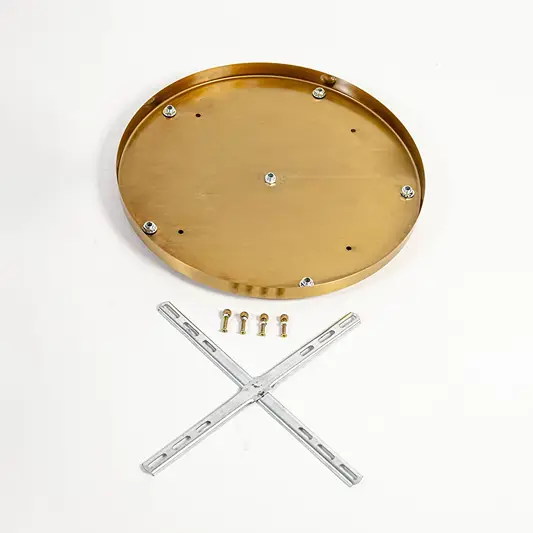 Gold metal ceiling plate with mounting hardware for pendant light chandelier and ceiling lighting on white background.