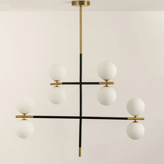 Frosted glass globe chandelier with gold accents and black metal frame designed for elegant modern ceiling lighting.