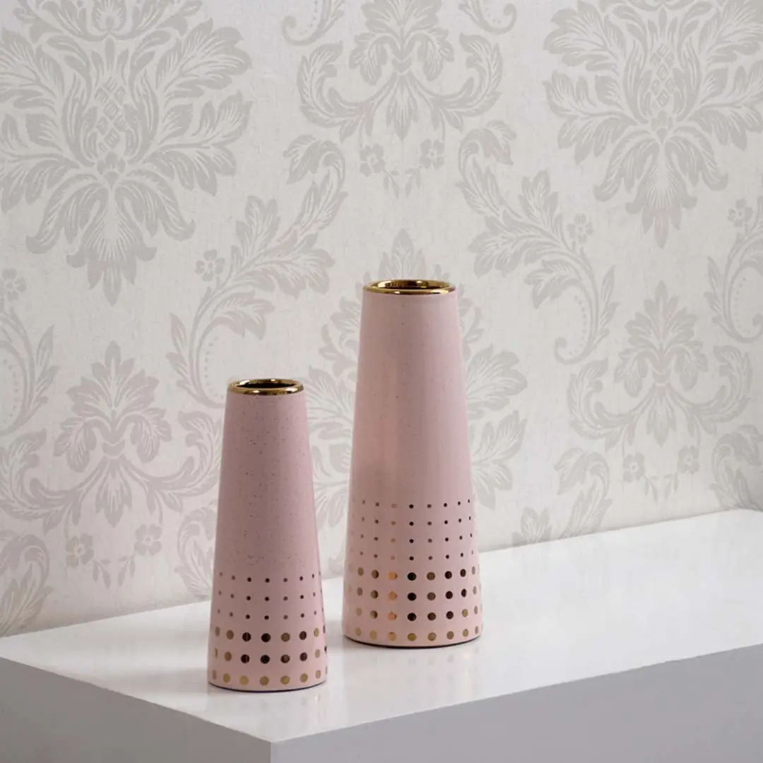 Pink ceramic vase with gold accents shown in a grouped decor setup highlighting its modern dotted pattern for elegant interior styling.