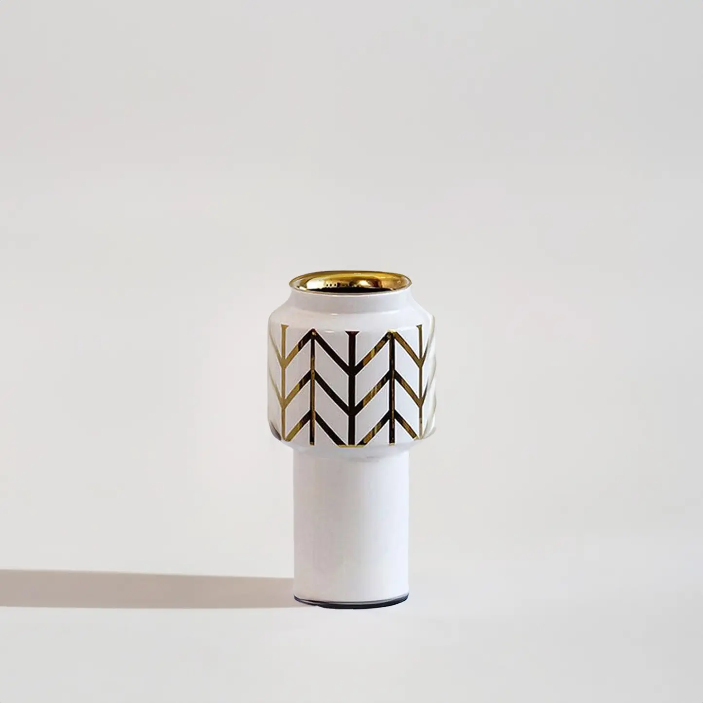 White ceramic decorative vase with black geometric pattern and gold rim for elegant contemporary home decor styling.
