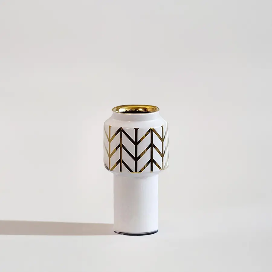 White ceramic decorative vase with black geometric pattern and gold rim for elegant contemporary home decor styling.