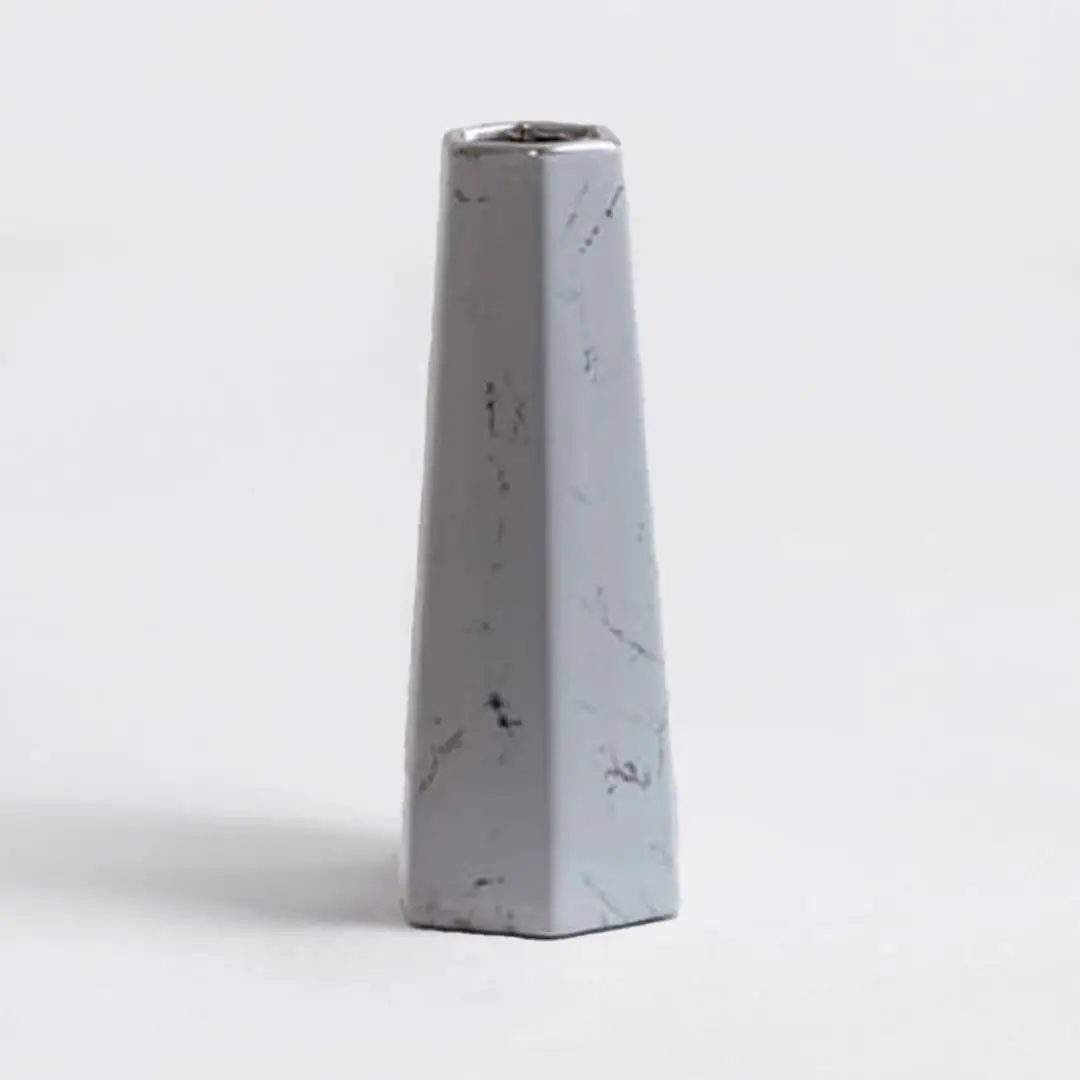Modern white marble ceramic vase with smooth finish and geometric design crafted for stylish living room decor.
