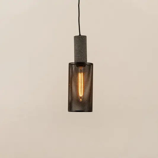 Smoky ribbed glass pendant light with black metal frame creating warm ambient glow for modern interiors.