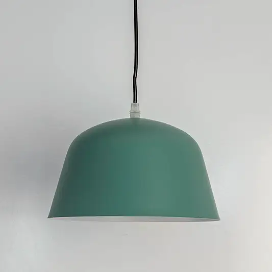 Matte green metal dome pendant light with smooth finish crafted for modern kitchens and dining spaces.