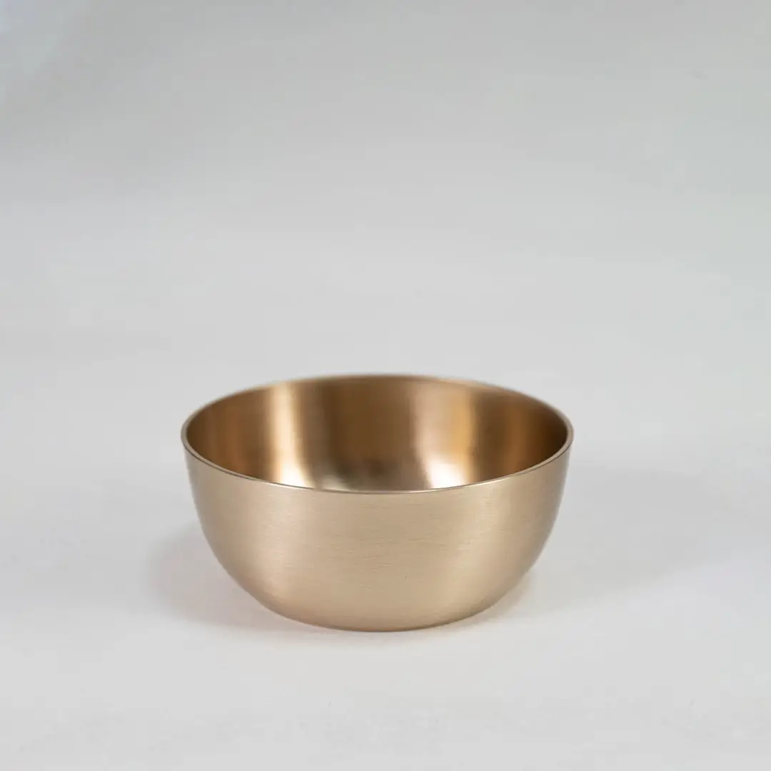 Plain brass tumbler with cylindrical shape and matte metallic finish displayed upright on clean white background.
