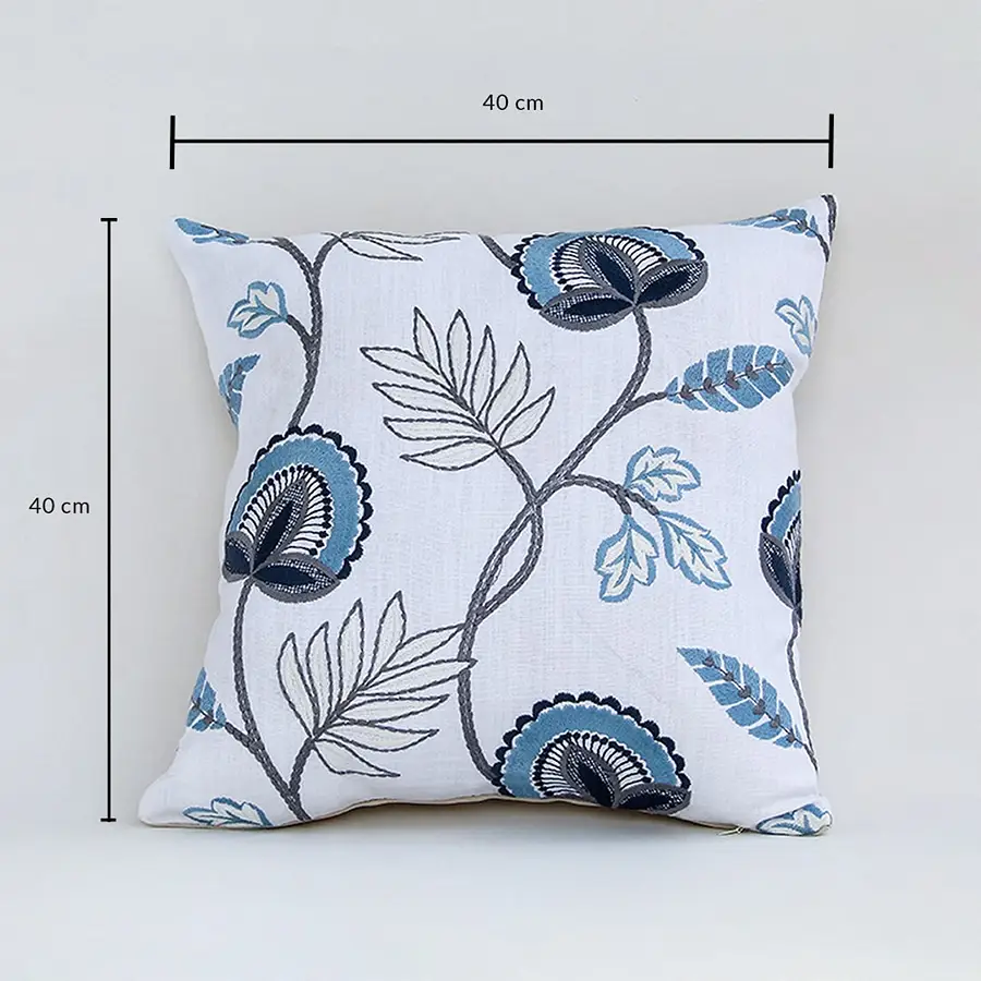 Soft cotton cushion cover with blue floral embroidery displayed with dimensions of 40 cm by 40 cm creating a cool nature inspired décor accent with a breathable gentle and skin friendly fabric.
