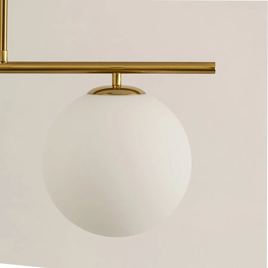 Frosted glass globe shade with gold metal bar detail highlighting premium materials and contemporary lighting design.