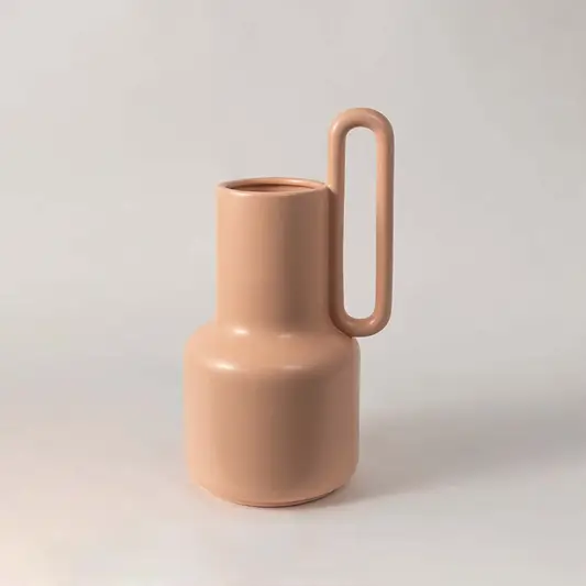 Modern matte peach ceramic single handle long neck jug vase displayed on a clean white background for contemporary art.