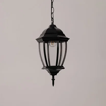 Contemporary black metal hanging lantern light with clear curved glass for stylish outdoor decor.