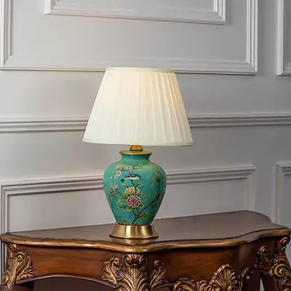 Table lamp with green ceramic base and white pleated shade on wooden console table classic decorative lighting for living room decor.