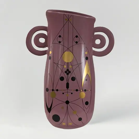 Mauve ceramic decorative vase with sculptural handles and gold detailing for modern shelf styling and home decor.