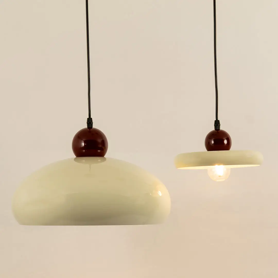 Modern cream pendant lights with burgundy accents for elegant dining room and kitchen decor styling inspiration.