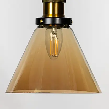 Amber glass cone pendant light with brass metal fixture showcasing glossy finish and contemporary lighting style.