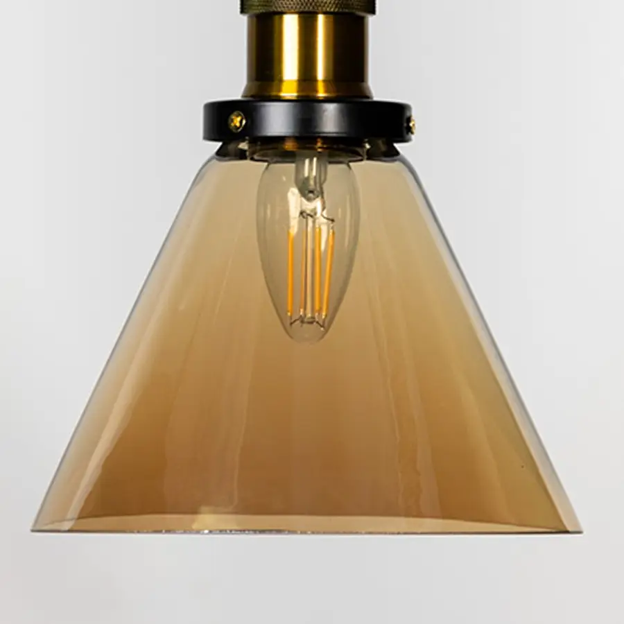 Amber glass cone pendant light with brass metal fixture showcasing glossy finish and contemporary lighting style.