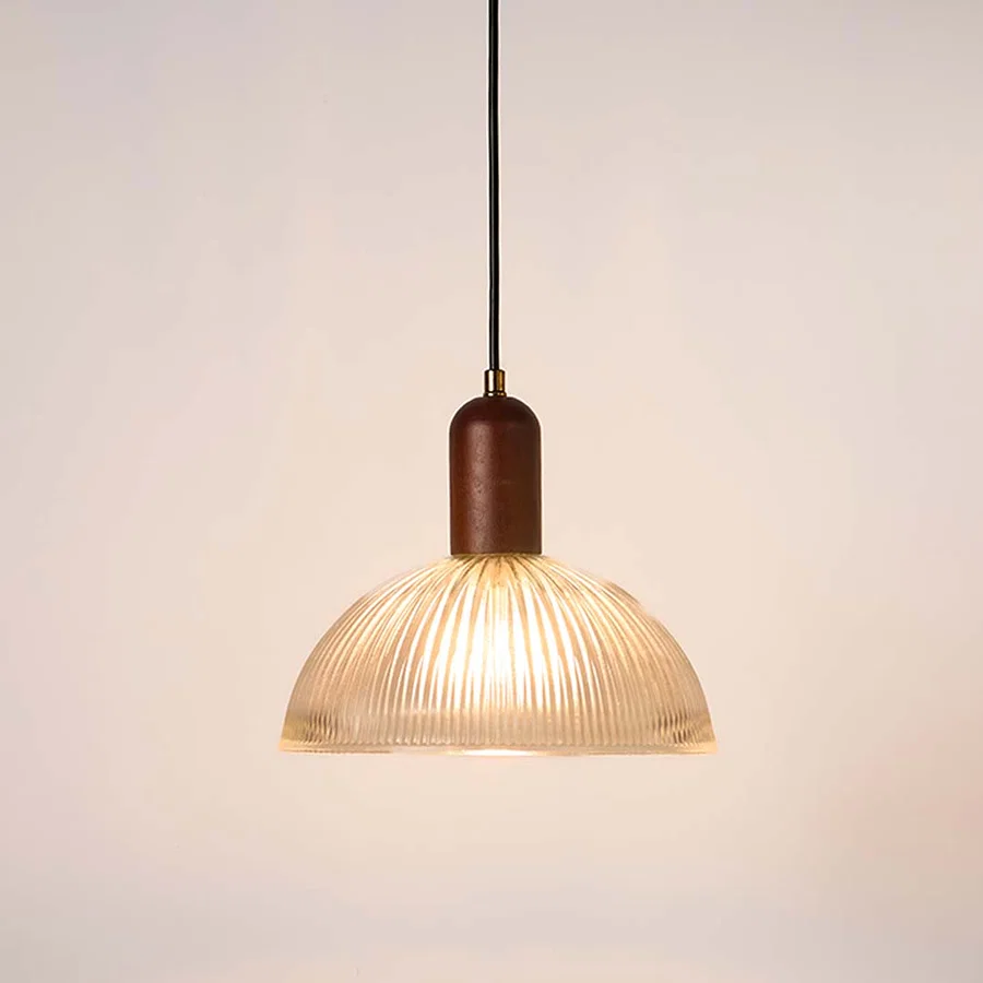 Ribbed clear glass and walnut wood pendant light with warm glow for elegant modern home decor spaces.