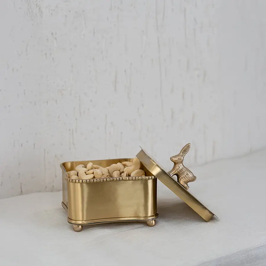 Gold bird-lid storage box securely packed in a premium black box with cushion insert for elegant gifting and safety.