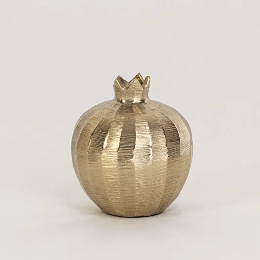 Mini gold pomegranate decor shown in styled interior without white background adding charm to seasonal decor