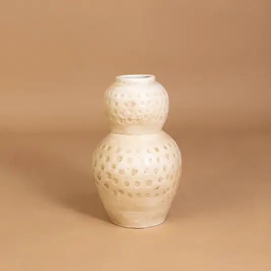 Elegant ceramic vase in off white finish with carved pattern for table decor or shelf styling modern home placement neutral background.