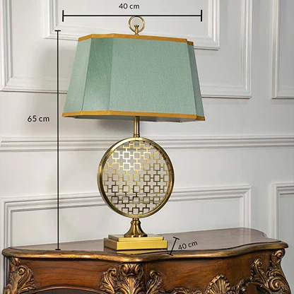 Green shade gold frame round table lamp on carved console table with light off for artistic decorative home décor.