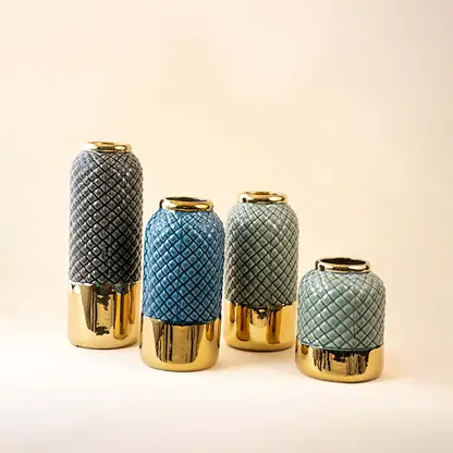 Set of green and blue ceramic decor vases with textured finish and gold base accents ideal for modern table styling on clean background.