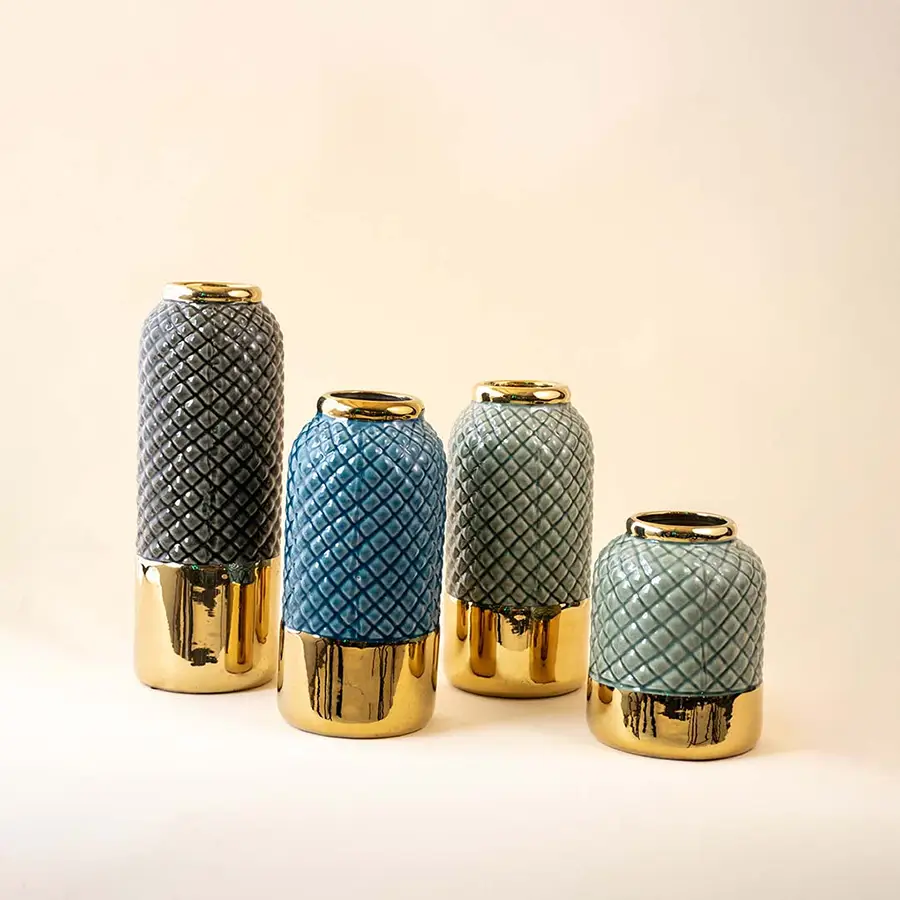 Set of green and blue ceramic decor vases with textured finish and gold base accents ideal for modern table styling on clean background.