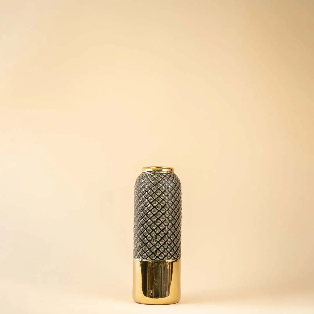 A tall grey and gold textured vase shown on a white background highlighting its glossy finish and modern geometric pattern in a clean bright setting.