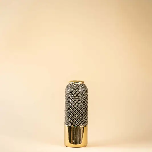 A tall grey and gold textured vase shown on a white background highlighting its glossy finish and modern geometric pattern in a clean bright setting.