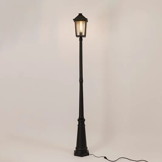 Illuminated black outdoor post lamp with glowing lantern head and textured glass panels on clean white background display.