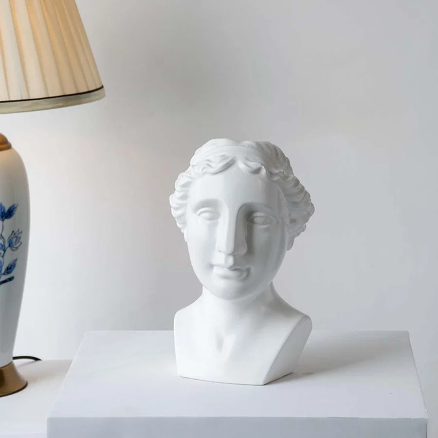 White decorative bust displayed in bright natural light creating a refined artistic accent perfect for shelves consoles and statement spaces.