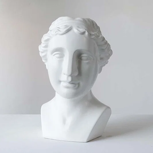 White ceramic decorative bust sculpture with classical Greek design for contemporary shelf styling and home decor.
