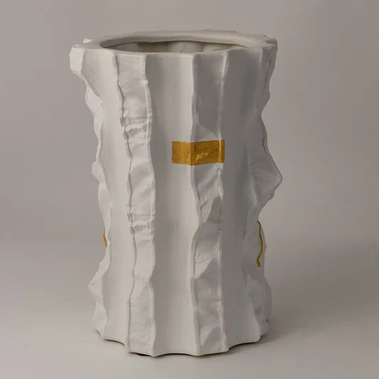 Closeup of Astra ceramic vase showing artistic folds and gold-painted textures crafted with precision for a luxurious finish.