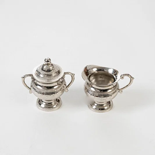 Elegant metal tea set in silver finish for dining table or serving decor accessory placement white background.
