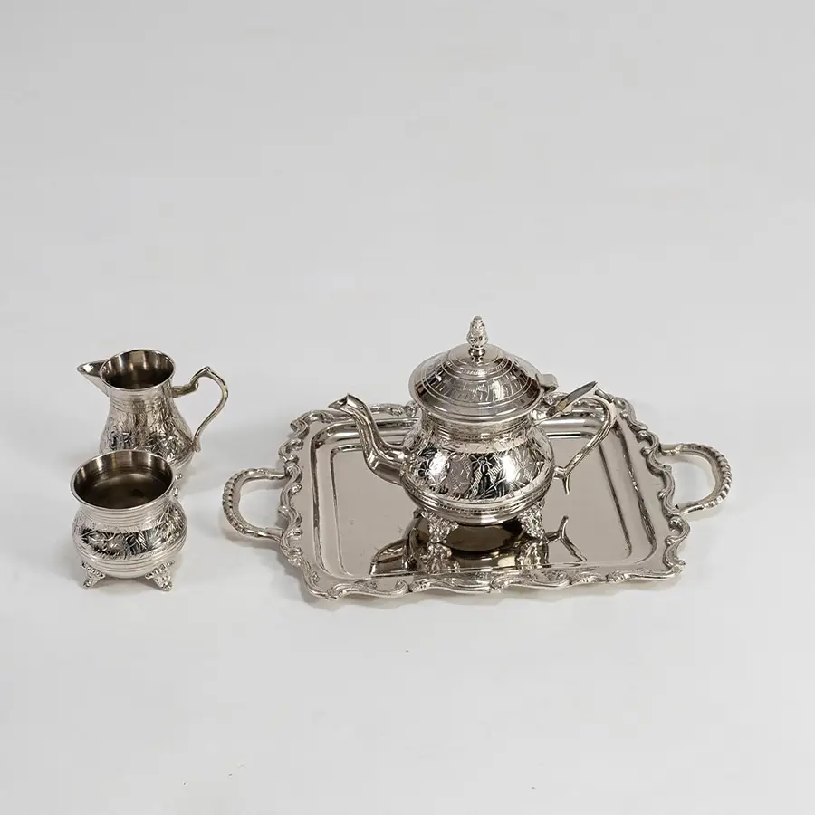 Silver tea set arranged securely in premium black box with foam inserts perfect for luxury gifting and protection.