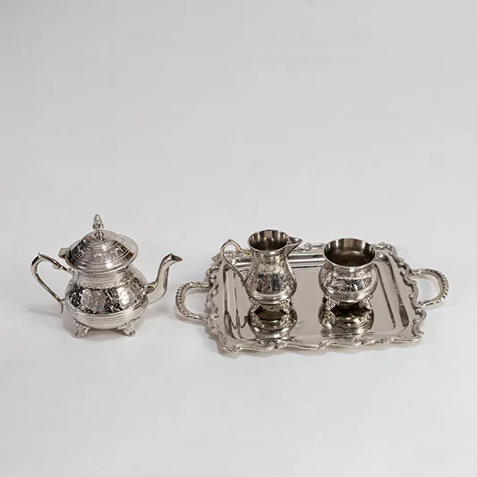Decorative metal tea set in silver finish for dining table or serving decor accessory placement white background.
