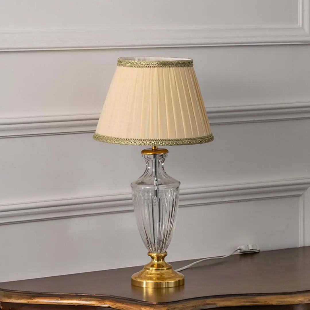 Clear etched glass table lamp with pleated fabric shade and brass accents designed for elegant traditional table lighting.