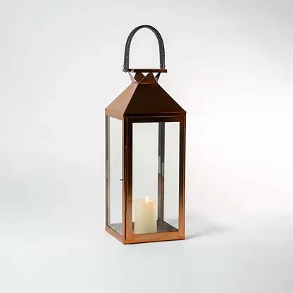 Lit bronze lantern against a white background showcasing its clean lines geometric roof and sleek metallic sheen.