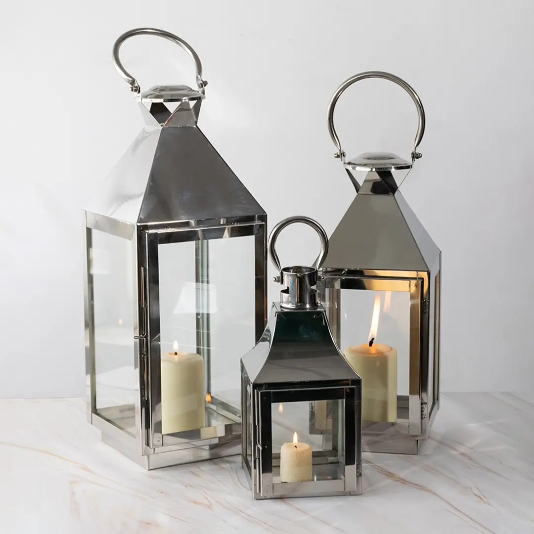 Black metal lantern candle holders with clear glass panels styled for dining table and modern home decor use.