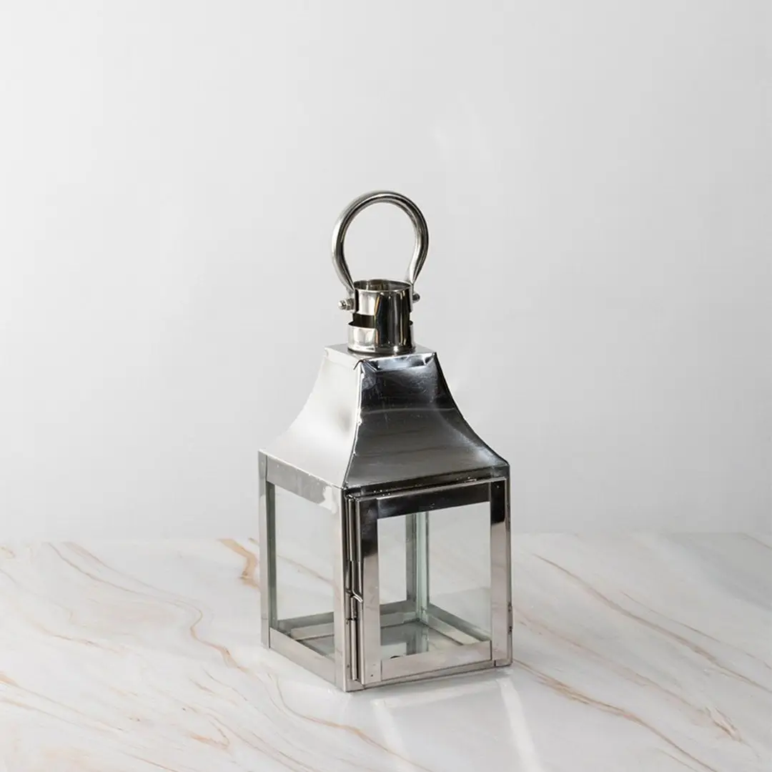 Silver lantern Unlit shown plain on white background highlighting polished stainless steel frame.