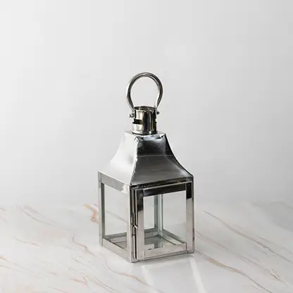 Silver lantern Unlit shown plain on white background highlighting polished stainless steel frame.