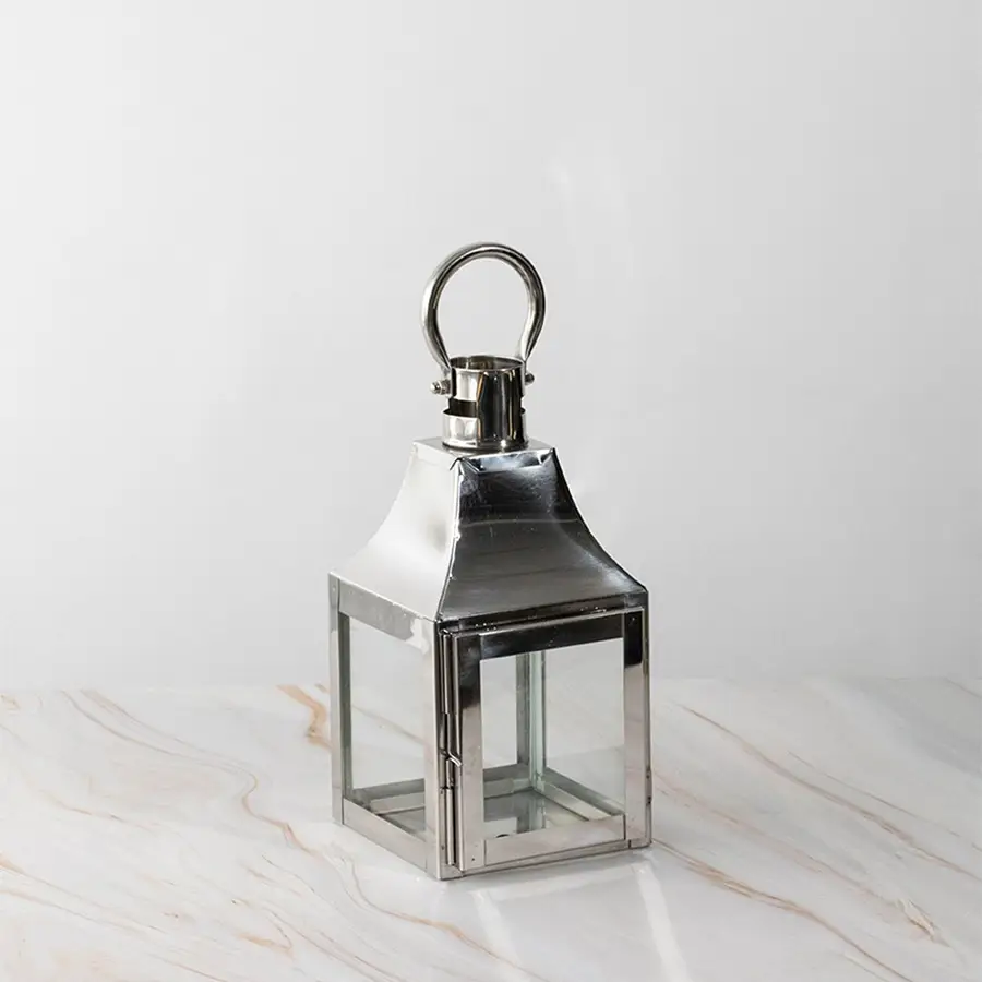 Silver lantern Unlit shown plain on white background highlighting polished stainless steel frame.