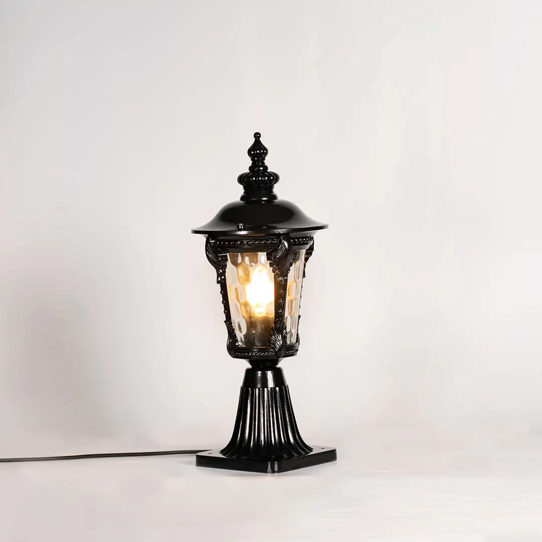 Vintage black outdoor gate light with warm glowing bulb for elegant exterior decor styling use.