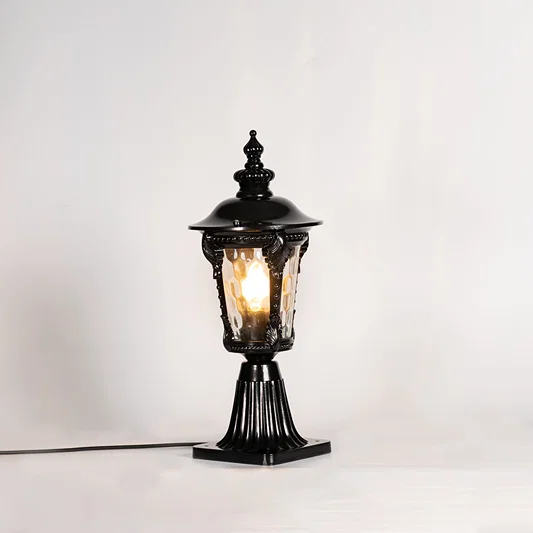 Vintage black outdoor gate light with warm glowing bulb for elegant exterior decor styling use.