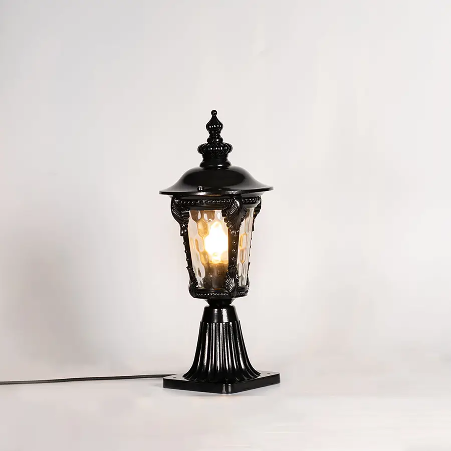 Vintage black outdoor gate light with warm glowing bulb for elegant exterior decor styling use.