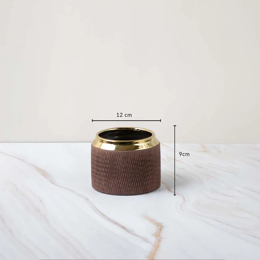 A brown textured vase with a gold rim shown with measurements of 12 cm width and 9 cm height clearly displaying its compact decorative size.