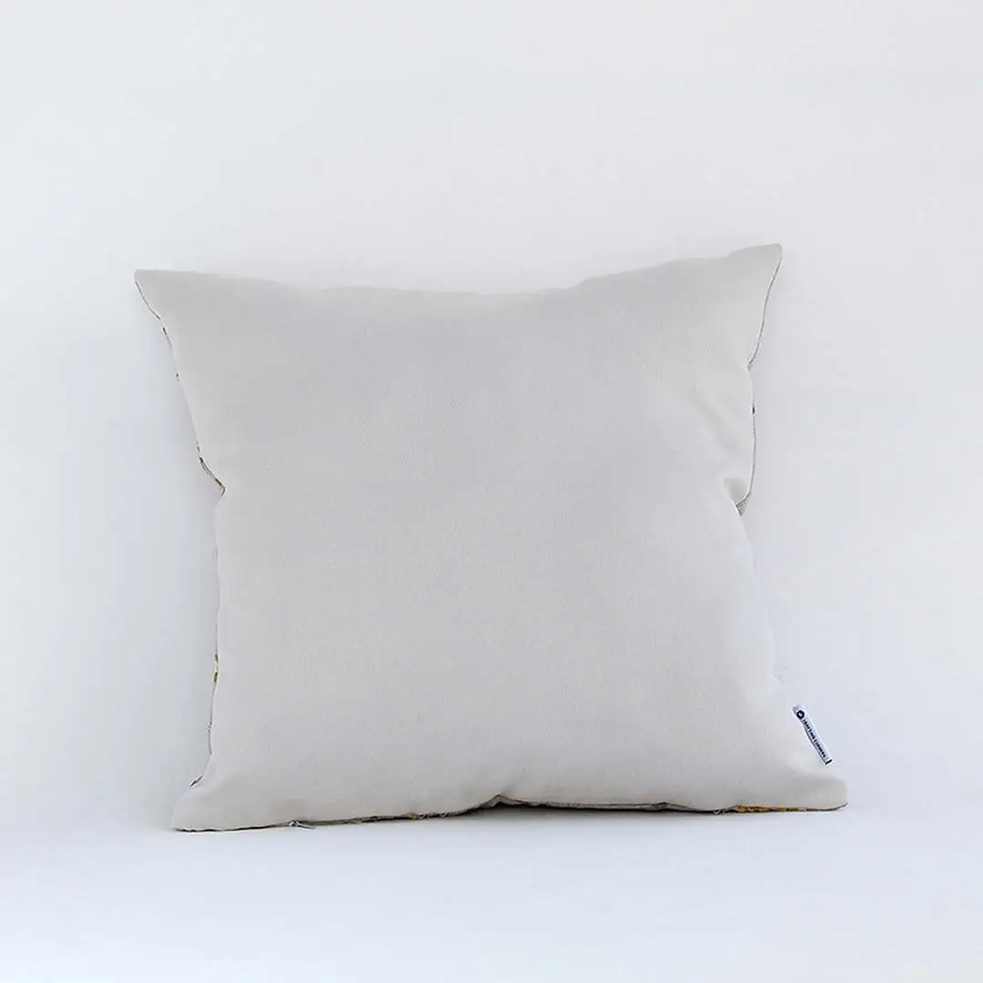 Back view of cotton cushion featuring plain white showing plush texture and fine stitching ideal for sofa and bed decor.