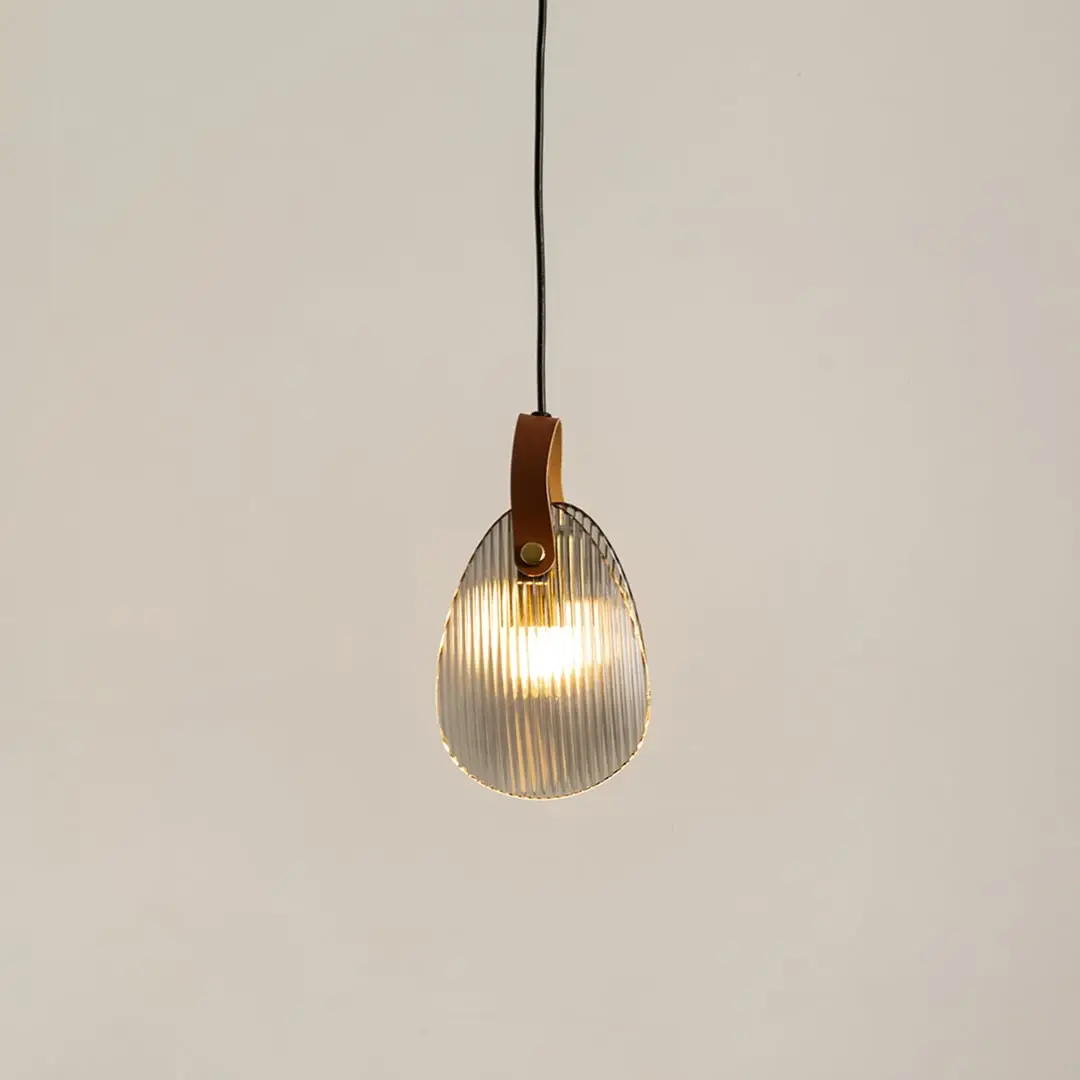 Amber glass pendant light illuminated to display elegant modern ceiling lighting with warm decorative styling.