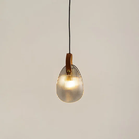 Amber glass pendant light illuminated to display elegant modern ceiling lighting with warm decorative styling.