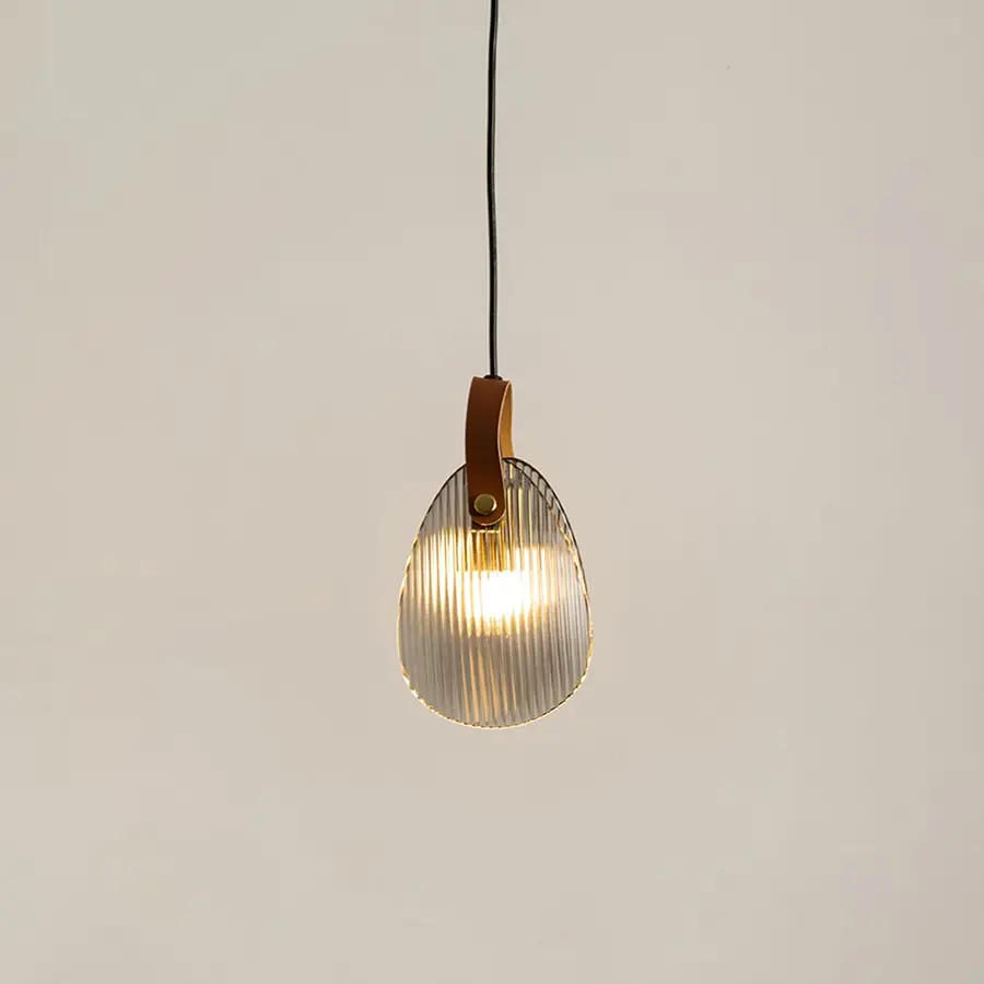Amber glass pendant light illuminated to display elegant modern ceiling lighting with warm decorative styling.