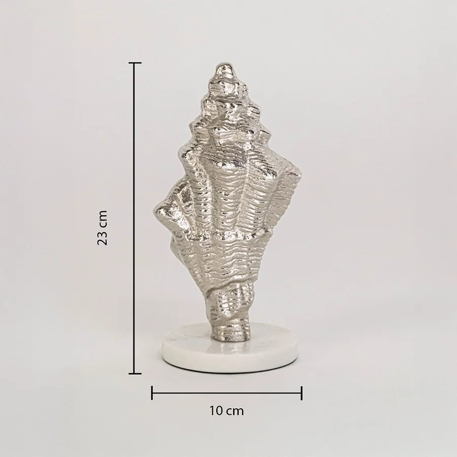 Decorative silver conch shell on white base measuring 23 cm high and 10 cm wide shown on clean white background